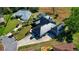 Stunning aerial view of the home, showcasing the unique roofline, manicured landscaping, and circular driveway at 1948 Spruce Creek Lndg, Port Orange, FL 32128