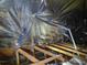 View of the attic, showcasing wooden beams and reflective insulation at 1948 Spruce Creek Lndg, Port Orange, FL 32128