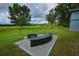 Beautifully landscaped backyard with a modern fire pit, custom seating, and serene views at 1948 Spruce Creek Lndg, Port Orange, FL 32128