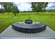 Inviting backyard area featuring a modern fire pit with concrete bench seating and lush green surroundings at 1948 Spruce Creek Lndg, Port Orange, FL 32128