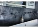 A modern bathroom featuring black fixtures, a sleek sink, and a decorative mirror at 1948 Spruce Creek Lndg, Port Orange, FL 32128