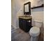 This bathroom offers a custom vanity with granite counters, undermount sink and toilet and wood look flooring at 1948 Spruce Creek Lndg, Port Orange, FL 32128