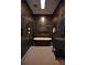 Modern bathroom featuring a sleek, black soaking tub and elegant dark walls at 1948 Spruce Creek Lndg, Port Orange, FL 32128