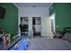 Comfortable bedroom featuring dual closets, a stylish green accent wall, and wood-look tile, combining functionality and appeal at 1948 Spruce Creek Lndg, Port Orange, FL 32128