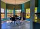 Dining room features bay windows, blue walls, and seating for four at 1948 Spruce Creek Lndg, Port Orange, FL 32128