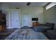 Living room with comfortable seating and media center, wood look tile floors and neutral walls at 1948 Spruce Creek Lndg, Port Orange, FL 32128