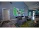 Relaxing living space with projector screen for entertainment, comfortable seating, and natural light at 1948 Spruce Creek Lndg, Port Orange, FL 32128