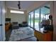Study featuring casual seating, ceiling fan, outdoor views and access to a screened in lanai at 1948 Spruce Creek Lndg, Port Orange, FL 32128