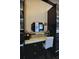 Bedroom closet vanity featuring marble countertops, mirror, and natural lighting at 1948 Spruce Creek Lndg, Port Orange, FL 32128