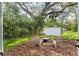 Serene backyard patio area with comfortable seating and a tranquil fire pit at 20 Warwick Ave, Ormond Beach, FL 32174