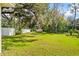 Expansive backyard with mature trees, lush lawn, and a privacy fence at 20 Warwick Ave, Ormond Beach, FL 32174