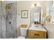 Modern bathroom showcasing a marble tiled shower, modern vanity, and brushed gold fixtures at 20 Warwick Ave, Ormond Beach, FL 32174