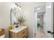 Bright bathroom with a modern vanity and black faucet, adjacent to a bedroom at 20 Warwick Ave, Ormond Beach, FL 32174