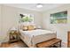 Charming bedroom featuring hardwood floors, white ceiling fan, and bright windows at 20 Warwick Ave, Ormond Beach, FL 32174