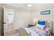 Bright bedroom with light-colored floors and walls, leading to an attached bathroom with a shower at 20 Warwick Ave, Ormond Beach, FL 32174