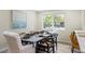 Elegant dining room with large window, sleek table setting, and light-colored walls at 20 Warwick Ave, Ormond Beach, FL 32174