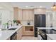 Spacious kitchen showcasing stainless steel appliances, light wood cabinetry, and elegant quartz countertops at 20 Warwick Ave, Ormond Beach, FL 32174