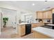 Modern kitchen with stainless steel appliances, stone countertops, and dining area in the background at 20 Warwick Ave, Ormond Beach, FL 32174