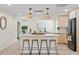 Beautiful modern kitchen with hardwood floors, light cabinets, and a large center island at 20 Warwick Ave, Ormond Beach, FL 32174