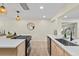 Open kitchen with a big island, quartz countertops, natural wood cabinets, and sleek stainless steel appliances at 20 Warwick Ave, Ormond Beach, FL 32174
