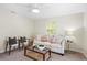 Bright living room featuring a ceiling fan, neutral paint, stylish decor, and a large window at 20 Warwick Ave, Ormond Beach, FL 32174