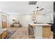 Open-concept living space with wooden floors, kitchen island, pendant lighting, and a cozy seating area at 20 Warwick Ave, Ormond Beach, FL 32174