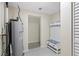 Practical utility room featuring a water heater and built-in storage bench with hooks at 20 Warwick Ave, Ormond Beach, FL 32174