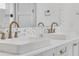 Bathroom featuring a double vanity with vessel sinks, modern faucets, and decorative backsplash at 213 Cedar Ave, New Smyrna Beach, FL 32169