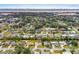Aerial neighborhood view of the home highlighting its location among lush greenery and waterways with the city skyline in the distance at 2211 Brian Ave, South Daytona, FL 32119