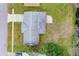An aerial view of the house showcasing its roof, driveway, and proximity to the street and adjacent green space at 2211 Brian Ave, South Daytona, FL 32119