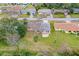 A yellow single Gathering home surrounded by mature trees and lush greenery in a suburban neighborhood at 2211 Brian Ave, South Daytona, FL 32119