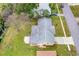 Aerial view of the home showing the roof, yard, driveway and nearby creek at 2211 Brian Ave, South Daytona, FL 32119