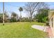 Large backyard with well-maintained lawn and patio area, offering outdoor living at 2211 Brian Ave, South Daytona, FL 32119