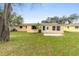 Spacious backyard with green grass and a patio, perfect for outdoor entertaining at 2211 Brian Ave, South Daytona, FL 32119