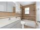 Bathroom featuring updated vanity, bathtub with shower and decorative shelving at 2211 Brian Ave, South Daytona, FL 32119