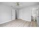 This light and airy bedroom features wood-look flooring, neutral walls, and a ceiling fan at 2211 Brian Ave, South Daytona, FL 32119