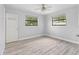 Bedroom with light wood flooring and dual windows for natural light at 2211 Brian Ave, South Daytona, FL 32119