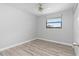 Bedroom with wood-look flooring, neutral walls and a large window at 2211 Brian Ave, South Daytona, FL 32119