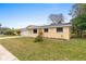 Charming single-story home with a well-manicured lawn and attached two car garage at 2211 Brian Ave, South Daytona, FL 32119