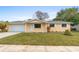 Charming single-story home with a well-manicured lawn and attached two car garage at 2211 Brian Ave, South Daytona, FL 32119