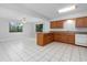 Eat-in kitchen with wood cabinets, island, and tile flooring at 2211 Brian Ave, South Daytona, FL 32119