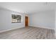 Bright living room with a window bringing in natural light and light wood floors at 2211 Brian Ave, South Daytona, FL 32119
