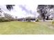 Lush backyard view with an inviting, screened-in pool area and mature trees at 2307 Needle Palm Dr, Edgewater, FL 32141