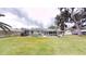 Spacious backyard features a screened-in pool and lush green lawn at 2307 Needle Palm Dr, Edgewater, FL 32141