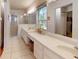 Spacious bathroom with double sinks, generous counter space, and a glass-enclosed shower at 2307 Needle Palm Dr, Edgewater, FL 32141