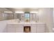 Bright bathroom featuring double sinks, ample counter space, and a well-lit vanity area at 2307 Needle Palm Dr, Edgewater, FL 32141