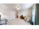 Well-lit bedroom featuring neutral carpet, a ceiling fan, and a large closet at 2307 Needle Palm Dr, Edgewater, FL 32141