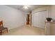 Neutral carpet bedroom showcasing a large closet and chair with exterior view at 2307 Needle Palm Dr, Edgewater, FL 32141