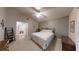 Comfortable bedroom with a decorative bed frame, carpeted floors, and a connected bathroom at 2307 Needle Palm Dr, Edgewater, FL 32141