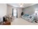 Comfortable carpeted bedroom with a ceiling fan, a sofa, and neutral walls at 2307 Needle Palm Dr, Edgewater, FL 32141